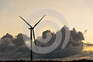 Silhouette wind generators turbines on sunset summer landscape i