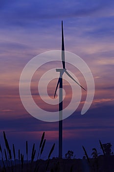 Silhouette wind turbine farm over moutain cloud in blue twilight