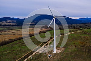 Silhouette of a wind turbine on a mountain at sunset, a windmill in the Ukrainian Carpathians, a windmill close up, top view