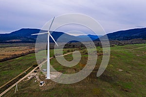 Silhouette of a wind turbine on a mountain at sunset, a windmill in the Ukrainian Carpathians, a windmill close up, top view
