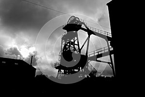 Silhouette of winding gear at mining pit head.