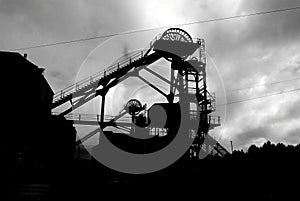 Silhouette of winding gear at mining pit head.