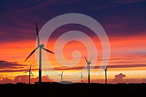Silhouette of windturbines on an amazing sunset