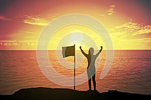 Silhouette of winning success woman at sunset or sunrise standing and raising up her hand near the flag in celebration