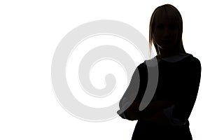 Silhouette of woman with arms crossed, half-turned