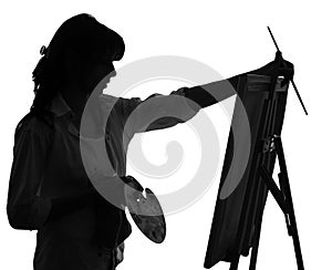 Silhouette of woman artist painting