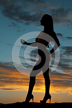 Silhouette woman bikini heels hand out