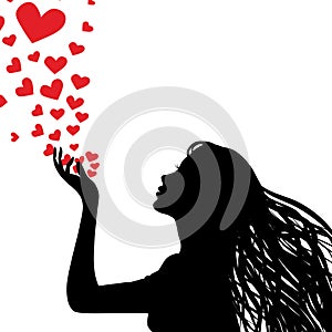 Silhouette woman blowing heart photo