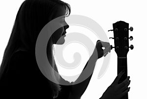 Silhouette of a woman configure a guitar