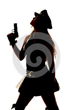 Silhouette of a woman cop gun close