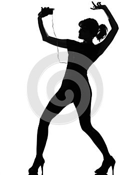 Silhouette woman dancing and listening music