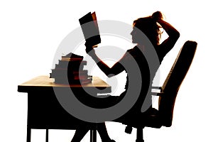 Silhouette woman at desk book pull hair