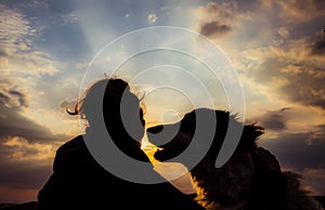 silhouette of woman and dog head at sunset pet teraphy