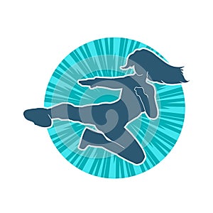 Silhouette of a woman doing a martial art kick.