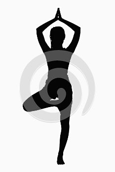 Silhouette of woman doing yoga pose.