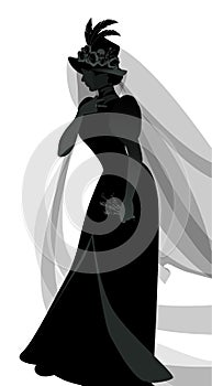 Silhouette of woman dressed in veils and ancient widow clothes carrying a sprig of flowers in one hand.