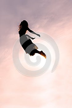 Silhouette of Woman Flying through Sky