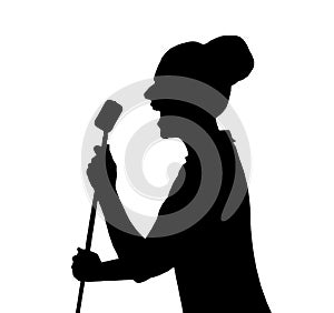 A silhouette of a woman in front of a microphone