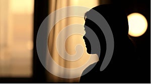 a silhouette of a woman in front of a window generated