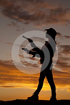 Silhouette woman guns side point