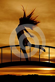 Silhouette of woman hair flying leg back