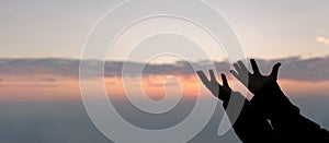 Silhouette of woman hand praying spirituality and religion, female worship to god. banner with copy space. Religious people are