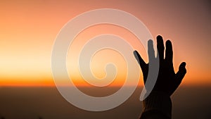 Silhouette of woman hand praying spirituality and religion, female worship to god. banner with copy space. Religious people are