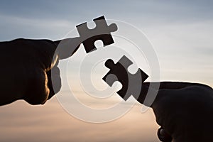 Silhouette Woman hands connecting couple puzzle piece against sunrise, Business solutions, target, success, goals and strategy co