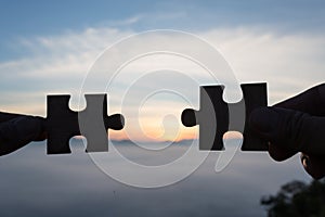 Silhouette Woman hands connecting couple puzzle piece against sunrise, Business solutions, target, success, goals and strategy co