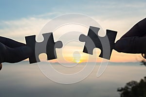 Silhouette Woman hands connecting couple puzzle piece against sunrise, Business solutions, target, success, goals and strategy co