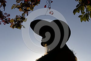 Silhouette of woman in hat