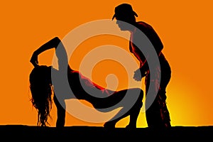 silhouette of woman in heels lean back on one hand look at cowboy