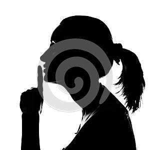 Silhouette of woman with hush sign