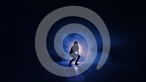 Silhouette of a woman jumping in front of a blue light