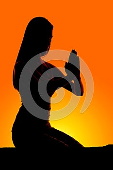 Silhouette woman kneel pray