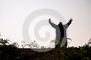 Silhouette of woman kneeling down praying for worship God at white background. Christians pray to jesus christ for calmness. In