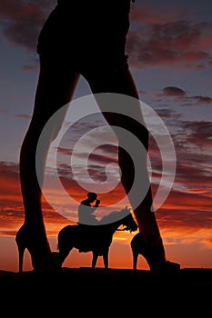 Silhouette woman legs face side cowboy horse