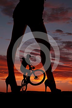 Silhouette woman legs face side man on bike