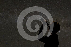 Silhouette of woman looking at stars