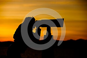 Silhouette of Woman Looking Through Telescope photo