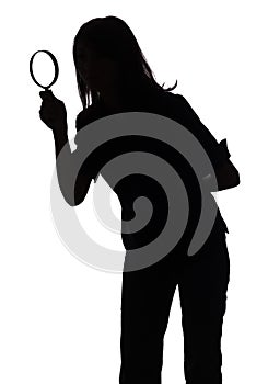 Silhouette of woman with magnifying glass photo