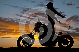 Silhouette woman motorcycle stand hands back