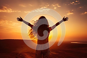 Silhouette of a woman with open arms on a sunset background, Excited girl standing and celebrating success on a sunset background