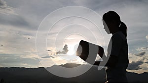 Silhouette of woman opening bible understand the bible to pray to god and ask god to protect you and your family. Ideas about