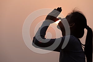 Silhouette of a woman paying respects and praying A symbol of gratitude to the Lord