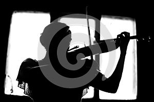 silhouette of a woman playing violin