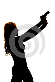 Silhouette of a woman pointing a gun to the side close