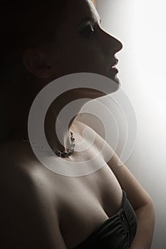 Silhouette of woman posing with hard shadows in studio, sexy