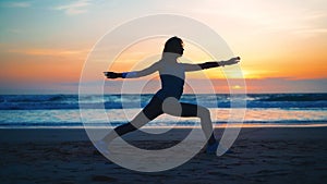 Silhouette Woman practice yoga warrior pose to meditation with summer vacation beach happiness and relaxation. Calm female