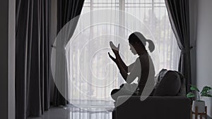 silhouette of woman praying to god Highest faith in religion and belief in God based on prayer. The power of hope or love and